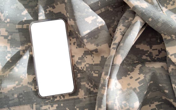 Blank mobile phone on military equipment, template for SMS, Ukrainian Armed Forces photo
