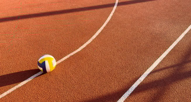 volleyball. blue with yellow color ball on the playground. volleyball cover, red. ball game photo