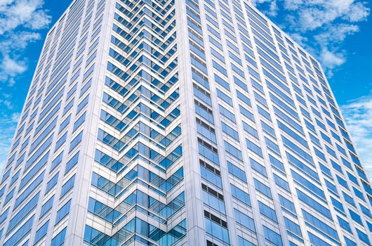 Skyscraper glass building of corporate headquarters in the downtown business area. Towering facade and windows embodying sleek, modern office environment. Financial institution. Modern architecture. photo