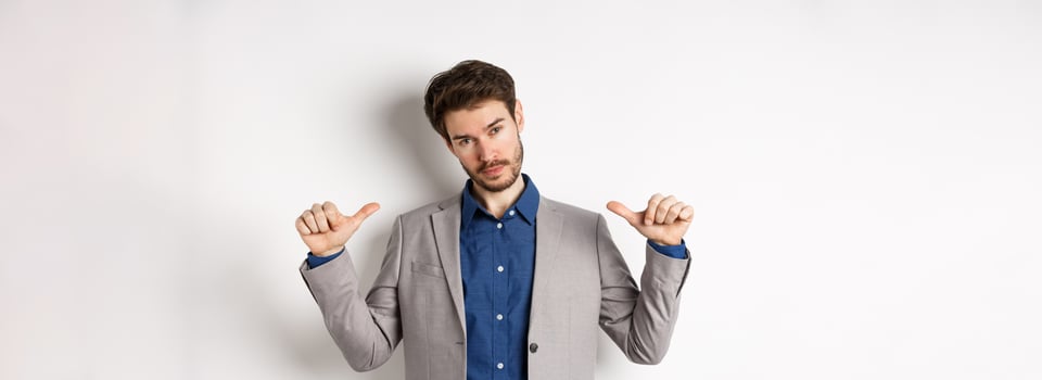 Confident man in business suit looking like professional, pointing at himself, self-promoting, standing on white background photo