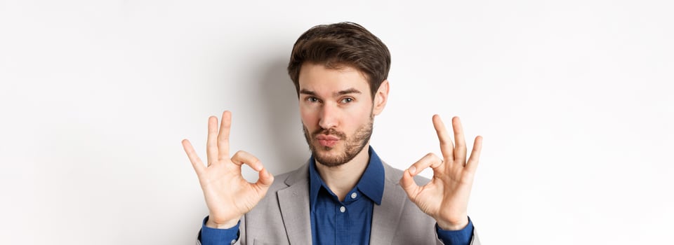 Not bad. Impressed caucasian businessman nod in approval, showing okay signs to praise and make compliment, white background photo
