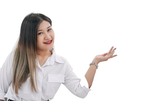 A young Asian woman with a joyful expression raises her left hand in the air and can use it to present or promote products. photo