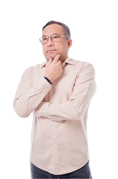 Asia man in glasses is looking down and thinking. He is wearing a white shirt and black pants photo