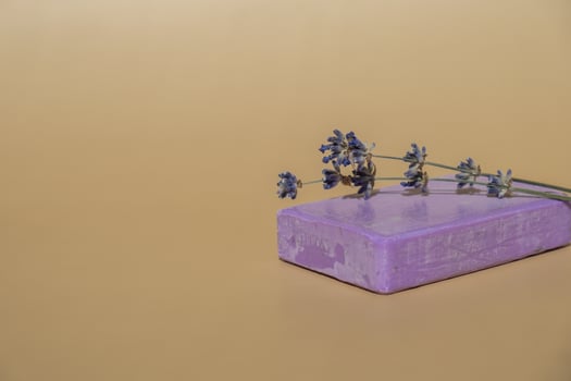 Handcrafted purple lavender soap with lavender flowers. Natural hydrating moisturiser softness cosmetic. Organic calming beauty skincare product. Herbal self care wellness alternative soap. Copy space photo