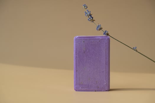 Handcrafted purple lavender soap with lavender flowers. Natural hydrating moisturiser softness cosmetic. Organic calming beauty skincare product. Herbal self care wellness alternative soap. Copy space photo
