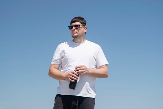 Sportive man workout drinking water from bottle photo