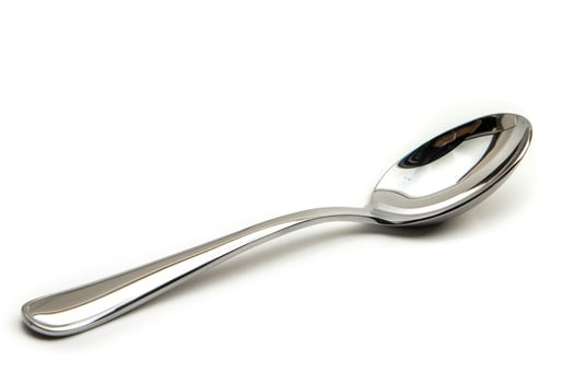 A silver metal spoon isolated on a white background. photo