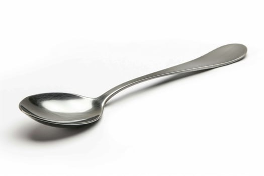 A silver metal spoon isolated on a white background. photo