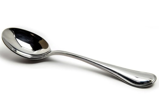 A silver metal spoon isolated on a white background. photo