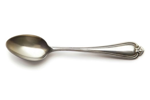 A silver metal spoon isolated on a white background. photo