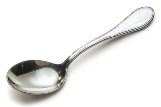 A silver metal spoon isolated on a white background. photo