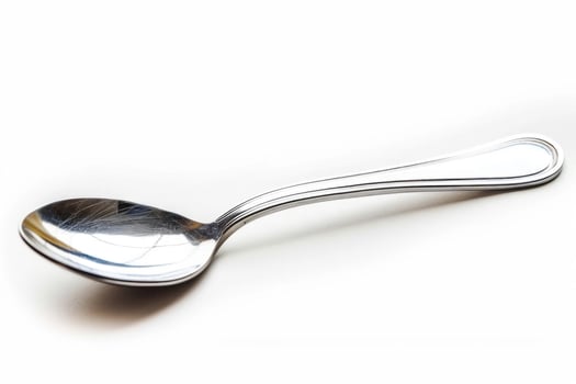 A silver metal spoon isolated on a white background. photo