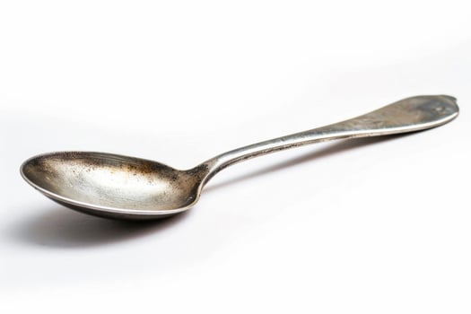 A silver metal spoon isolated on a white background. photo