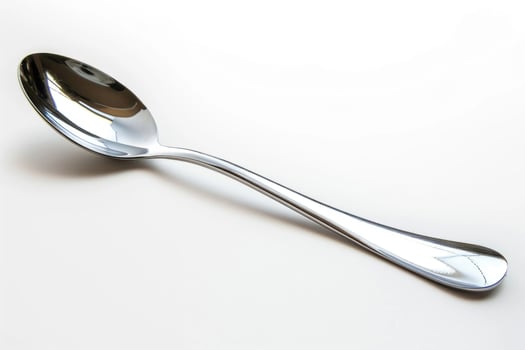 A silver metal spoon isolated on a white background. photo