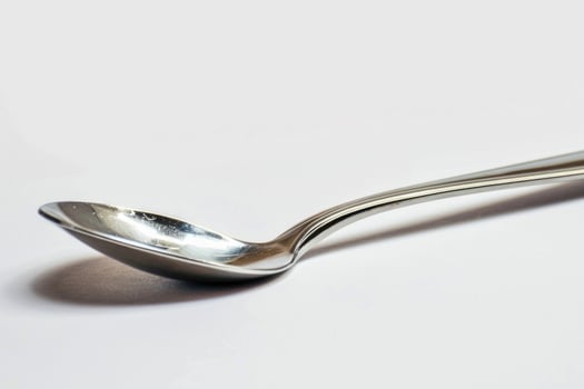 A silver metal spoon isolated on a white background. photo