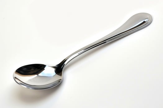 A silver metal spoon isolated on a white background. photo