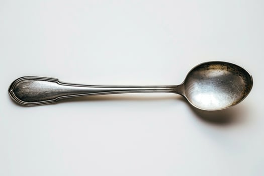 A silver metal spoon isolated on a white background. photo