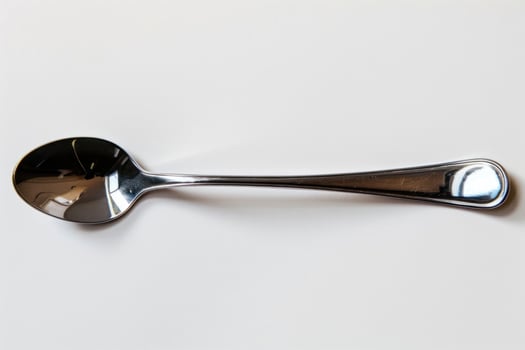 A silver metal spoon isolated on a white background. photo