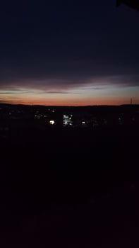 Bright sunset casts colors over the bustling city below photo
