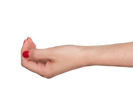 Cupped hand with palm up, symbolizing charity and help. Young womans hand, with red manicure, photo