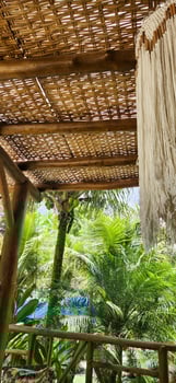 tropical house with red hammock with tropical plants outdoors photo