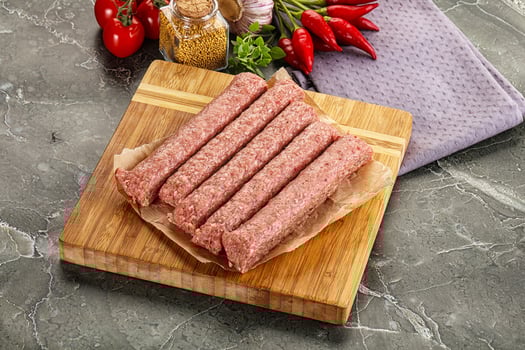 Raw beef kebab sausage for grill photo