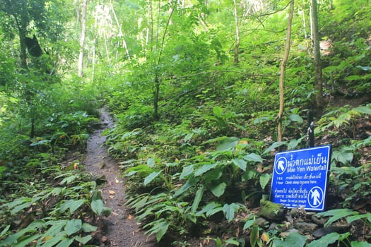 Pai, Thailand - October 12, 2015 A road sign in the Jungle which points to Mae Yen Waterfall. Danger. Do not go straight A dangerous trail to the waterfall. photo