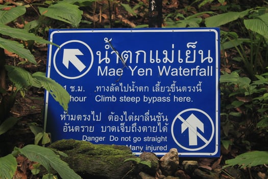 Pai, Thailand - October 12, 2015 A road sign in the Jungle which points to Mae Yen Waterfall. Danger. Do not go straight photo