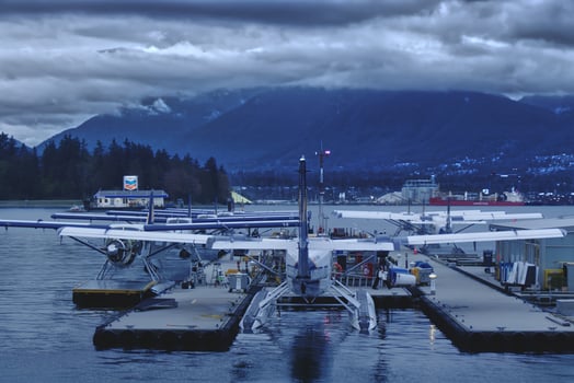 Vancouver, Canada - September 19, 2019 View of Vancouver Harbour Flight Centre. Seaplanes on the water with a dark clouds background photo