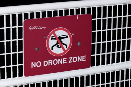 Vancouver, Canada - September 18,2019 Red Warning Sign No Drone Zone found on the Canada Place fence at the Port of Vancouver photo
