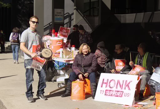 Vancouver, Canada - September 27,2019 Activists are sitting on Hastings Street in front of Pinnacle Hotel. Striking hotel workers block sidewalk in downtown Vancouver photo
