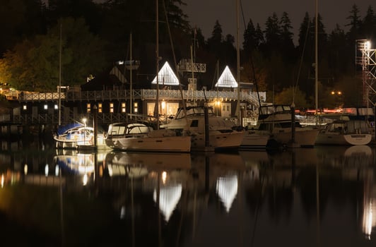Vancouver, Canada - September 25, 2019 Long Exposure photo of Vancouver Rowing Club at night with the marina docks full of sailboats. Seawall in Stanley Park.