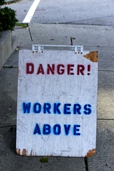 View of sign Danger, Workers above on sidewalk in Vancouver, Canada. photo