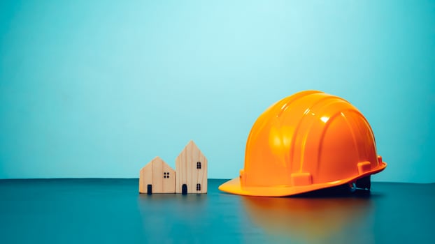 Hard hat for construction site workers and for engineers or workers, Standard safety helmet head protection, Wooden house model with hard hat with copy space, Engineering construction concept. photo