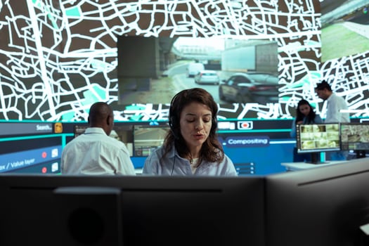 Agency dispatcher communicates cargo gps coordinates to clients, handling any order delay complains at call center department. Employee monitoring couriers stuck in heavy traffic. photo