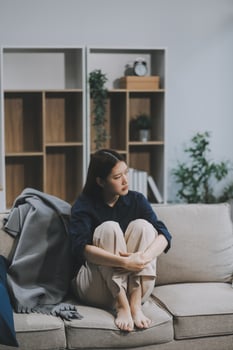A woman with a cold with pills is treated at home chooses which drugs to take and self-medicates, checks the expiration date while sitting on the couch at home photo