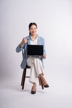 Portrait of young businesswoman posing on white background photo