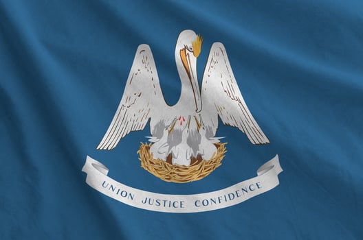 Louisiana US state flag depicted on folded wavy fabric of old cloth photo