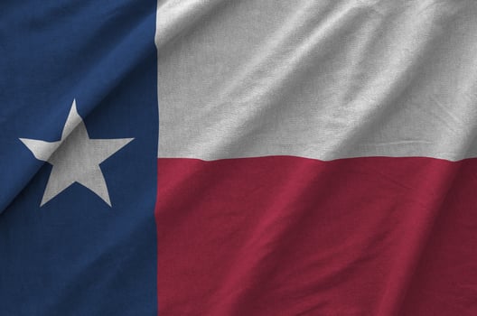Texas US state flag depicted on folded wavy fabric of old cloth photo