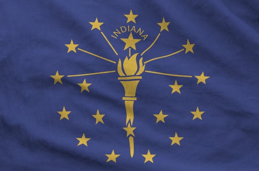 Indiana US state flag depicted on folded wavy fabric of old cloth photo