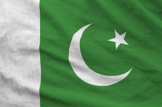 Pakistan flag depicted on folded wavy fabric of old cloth photo