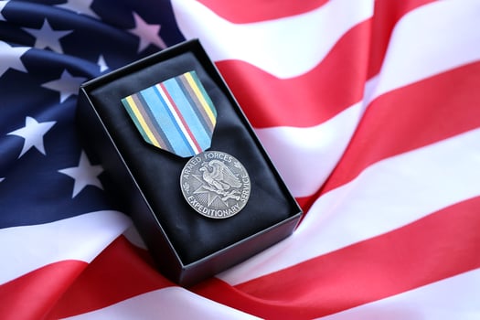 KYIV, UKRAINE - JULY 10, 2024 US Armed Forces Expeditionary medal. United States military award medal with ribbon and pin. Handmade paper theater props photo