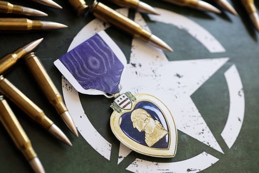 KYIV, UKRAINE - JULY 10, 2024 US Purple Heart medal. United States military award medal with ribbon and pin. Handmade paper theater props photo