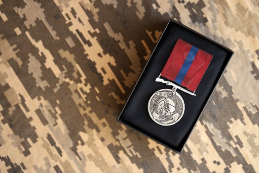 KYIV, UKRAINE - JULY 10, 2024 US Marine corps Army Good Conduct medal. United States military award medal with ribbon and pin. Handmade paper theater props photo