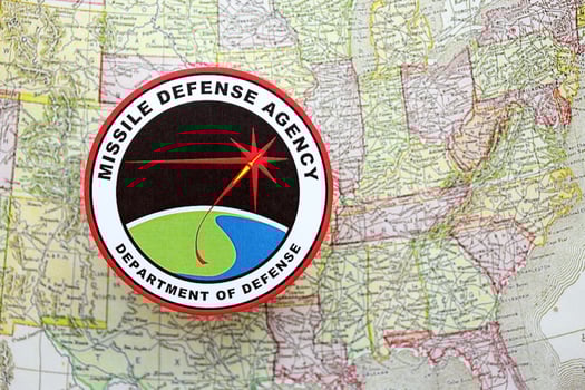 KYIV, UKRAINE - JUNE 26, 2024 Department of Defense Missile Defense Agency coat of arms on paper map of United States photo