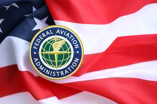 KYIV, UKRAINE - JUNE 26, 2024 Federal Aviation Administration coat of arms sticker on folded US flag photo