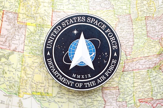 KYIV, UKRAINE - JUNE 26, 2024 United States Space Force Department of the Air Force coat of arms on paper map of United States photo