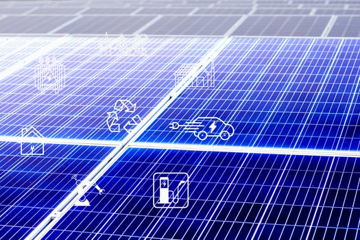 Solar cells have various symbols such as electric car charging station, robot, inverter, energy saving industry above the solar panels. photo
