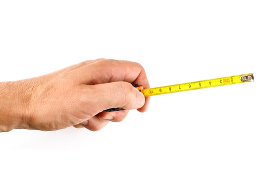 Folding tape measure in hand isolate photo