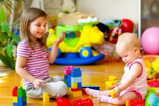 Sisters playing with toys at home photo
